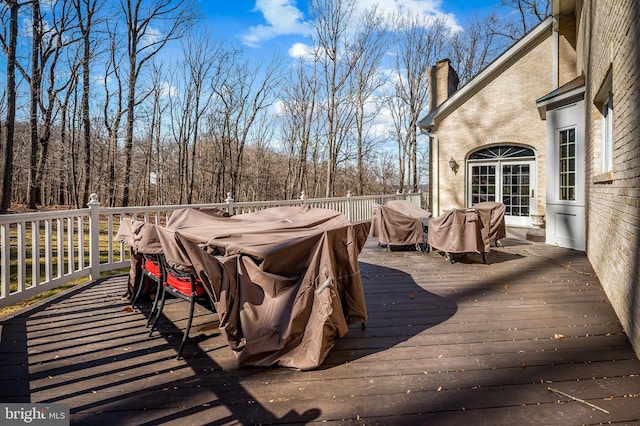 wooden deck with a view of trees