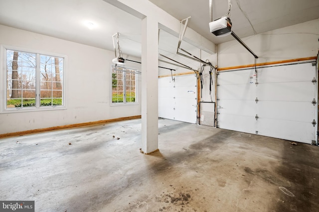 garage with baseboards and a garage door opener