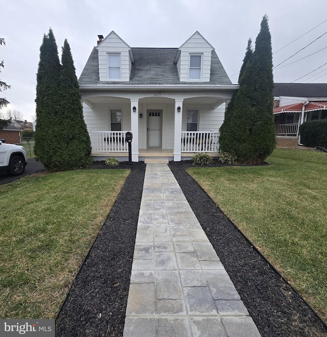 view of front facade with covered porch and a front yard