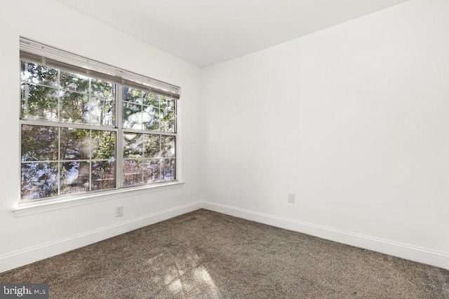 empty room with carpet and baseboards