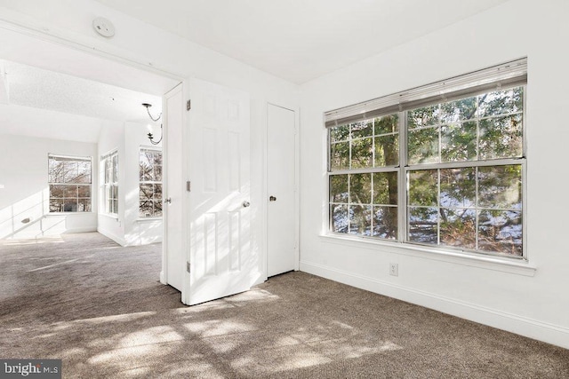 empty room with carpet and baseboards