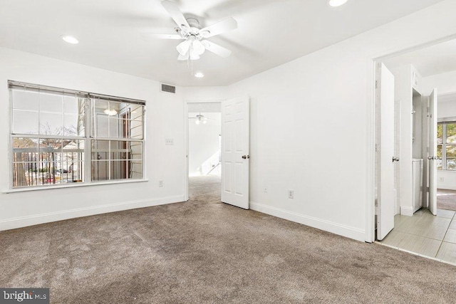 unfurnished bedroom with recessed lighting, light carpet, visible vents, and baseboards