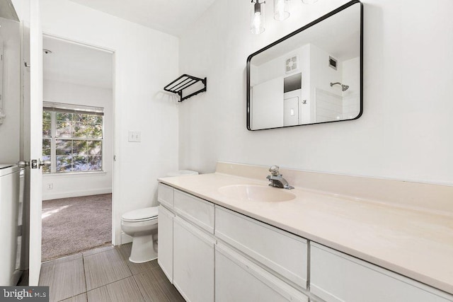 bathroom featuring toilet, visible vents, and vanity