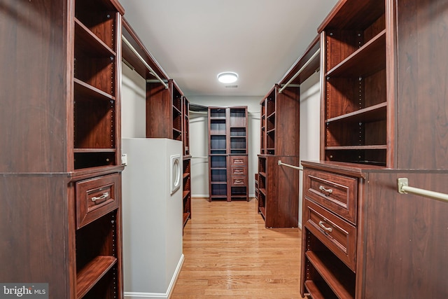 walk in closet with light wood-type flooring