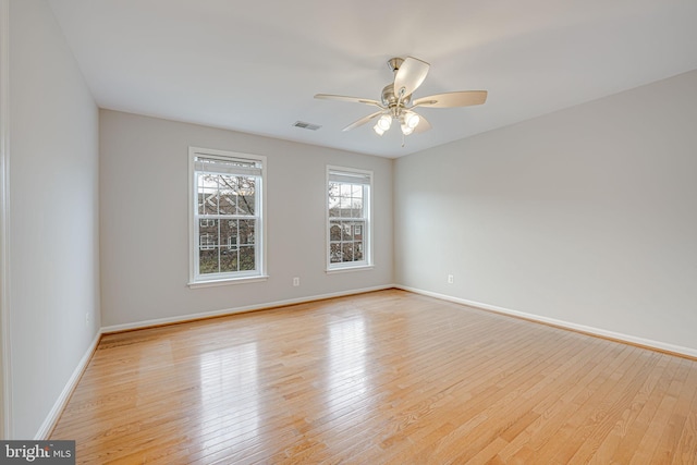 unfurnished room with ceiling fan and light wood-type flooring