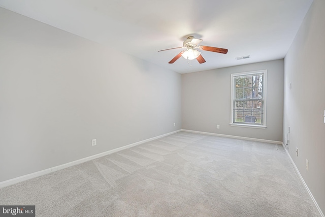 empty room featuring light carpet and ceiling fan