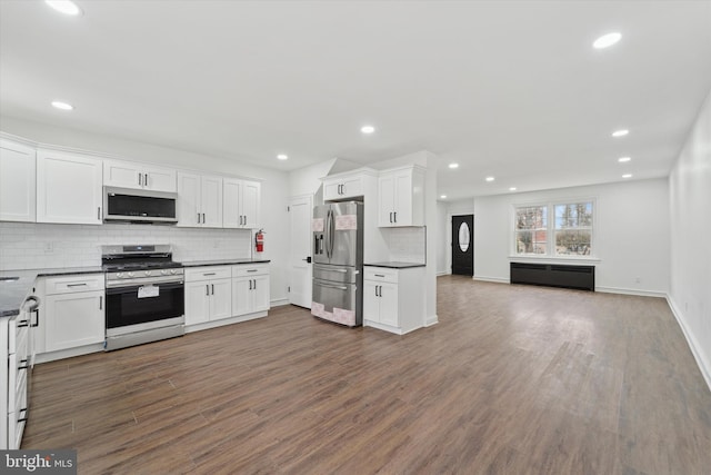 kitchen featuring tasteful backsplash, dark wood-type flooring, stainless steel appliances, and white cabinets