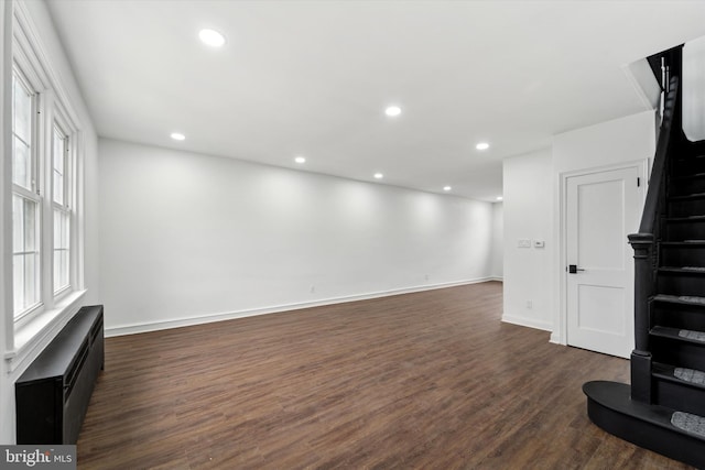 unfurnished living room with dark hardwood / wood-style floors