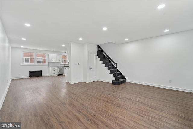 unfurnished living room with dark hardwood / wood-style floors