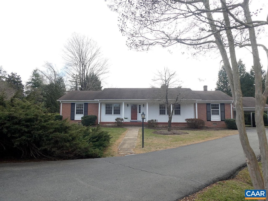 ranch-style home with a front lawn