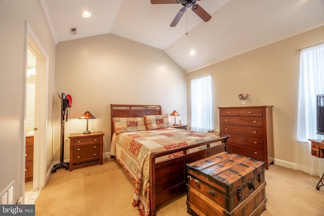 carpeted bedroom with ornamental molding, lofted ceiling, ceiling fan, and ensuite bath