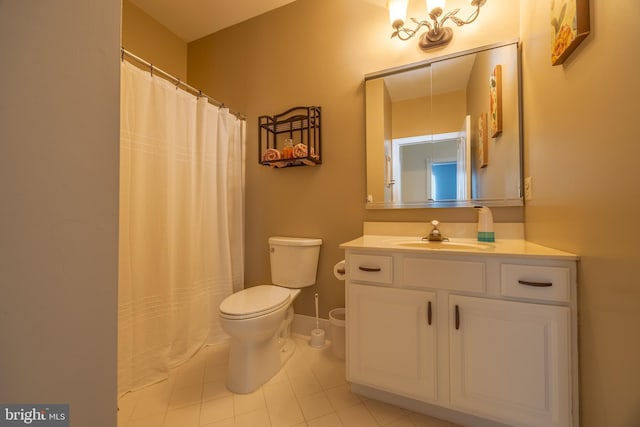 bathroom with vanity, tile patterned floors, and toilet