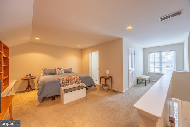 bedroom with vaulted ceiling and light carpet