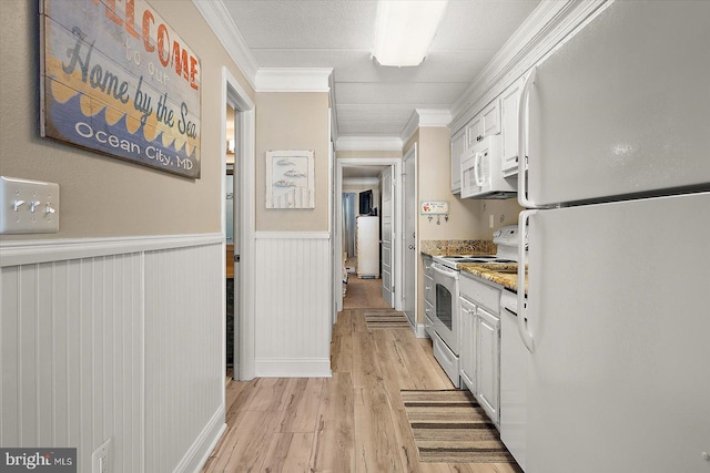 kitchen featuring light stone counters, crown molding, light hardwood / wood-style flooring, white appliances, and white cabinets