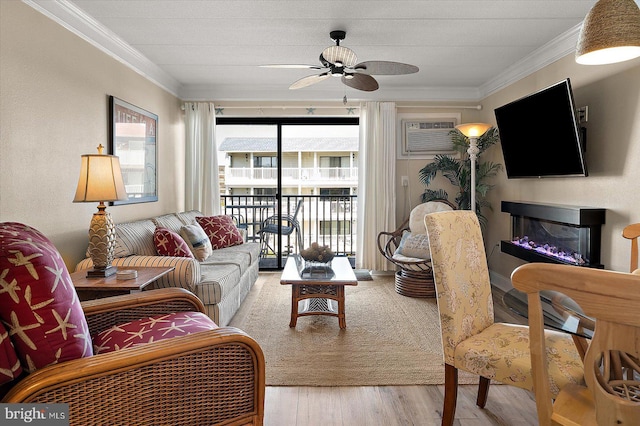 living room featuring crown molding, a wall mounted AC, ceiling fan, and light hardwood / wood-style floors