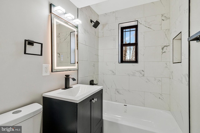 bathroom featuring toilet, vanity, and shower / tub combination