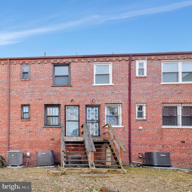 view of front of home featuring brick siding and central AC unit