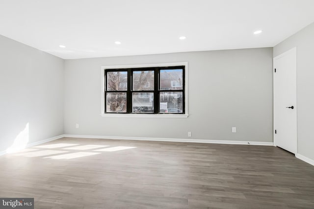 unfurnished room with recessed lighting, baseboards, and wood finished floors