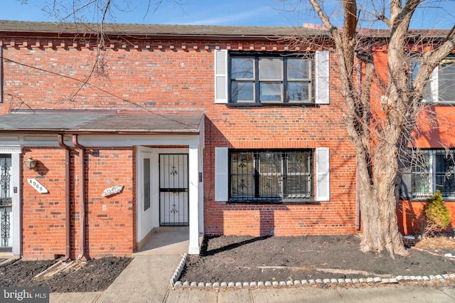 view of property featuring brick siding