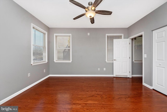 spare room featuring ceiling fan, wood finished floors, and baseboards