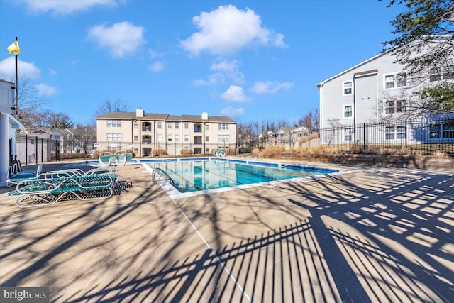 community pool featuring a patio and fence