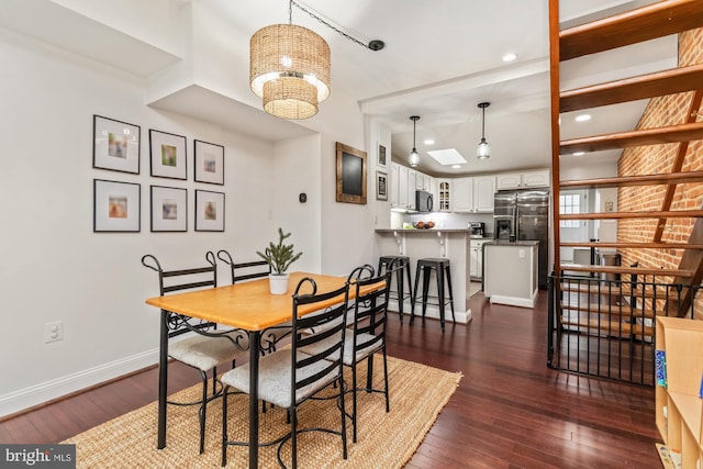 dining area featuring lofted ceiling, a notable chandelier, and dark wood-type flooring