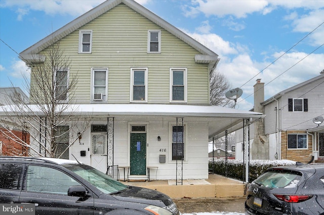 front facade featuring cooling unit and covered porch