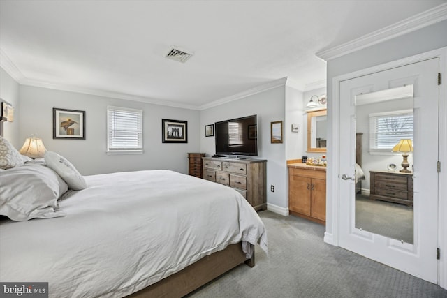 carpeted bedroom with crown molding and ensuite bath