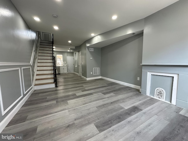 unfurnished living room with wood-type flooring