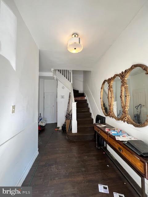 interior space with stairs and dark wood-type flooring