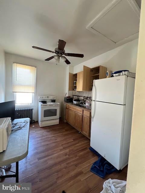 kitchen featuring white appliances, dark wood-style flooring, open shelves, radiator heating unit, and dark countertops