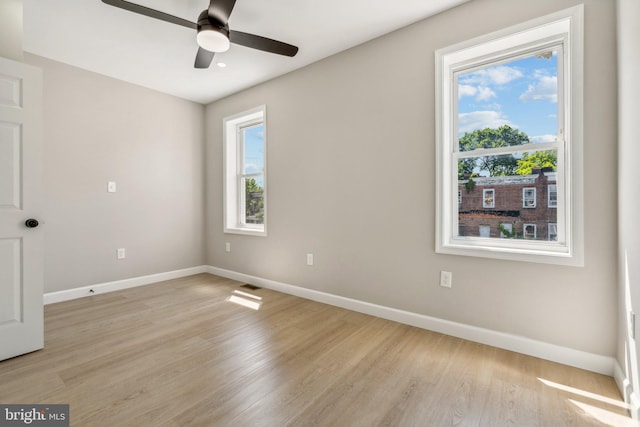 spare room featuring ceiling fan and light wood-type flooring