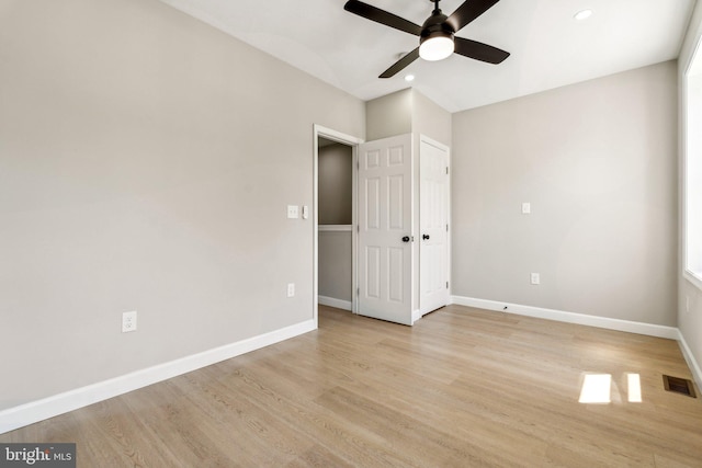 unfurnished bedroom with ceiling fan and light wood-type flooring