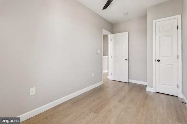 unfurnished bedroom with ceiling fan and light wood-type flooring