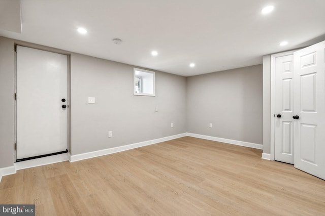 basement with light hardwood / wood-style flooring