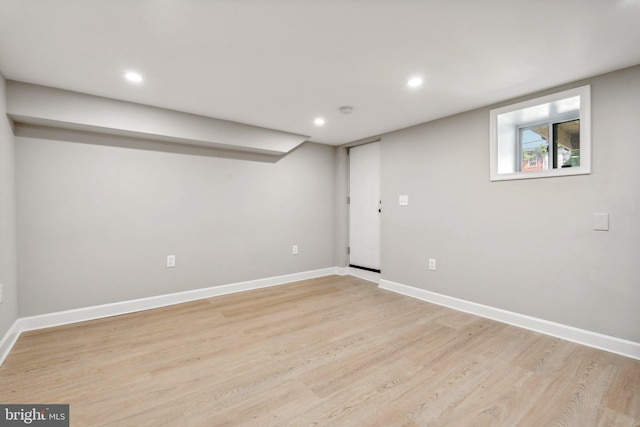 basement with light hardwood / wood-style floors