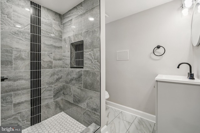 bathroom featuring vanity and a tile shower