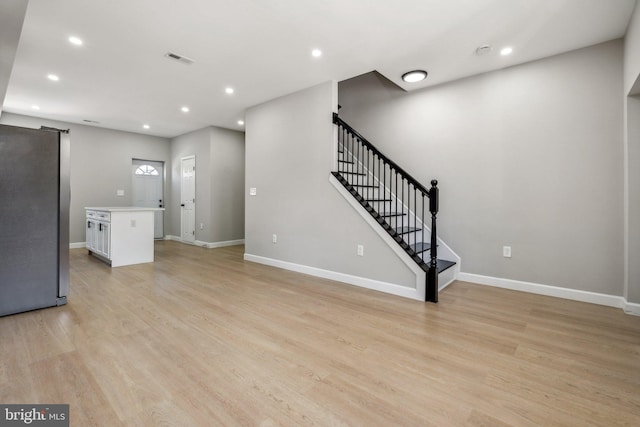 unfurnished living room featuring light wood-type flooring