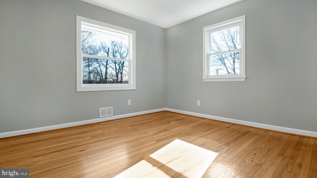 unfurnished room with light hardwood / wood-style floors