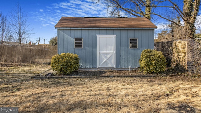 view of outbuilding with a yard