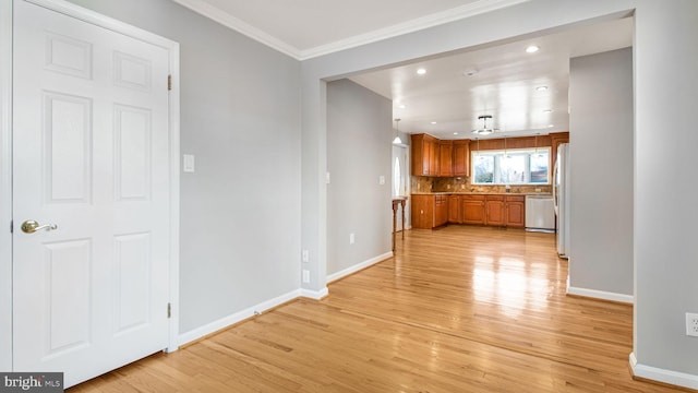 interior space with crown molding and light hardwood / wood-style floors