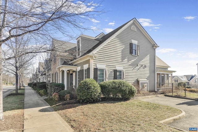 view of side of property with a lawn