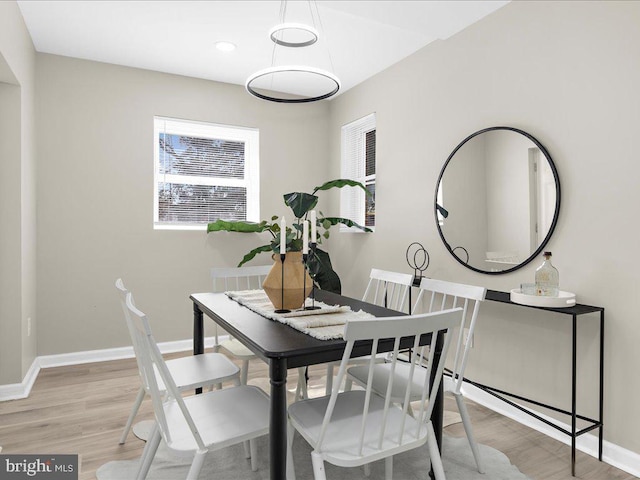 dining space featuring light wood-type flooring