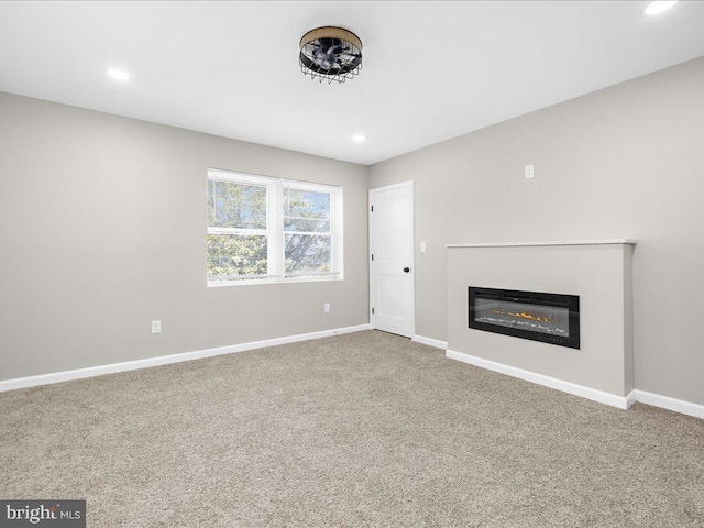 unfurnished living room with carpet flooring