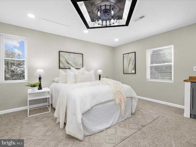 carpeted bedroom with a chandelier