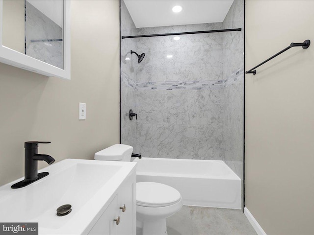 full bathroom with vanity, tiled shower / bath combo, and toilet