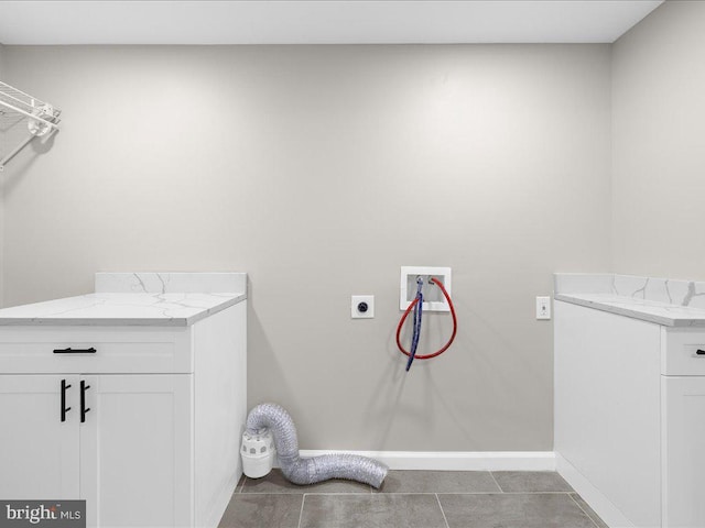 laundry area with hookup for a washing machine, electric dryer hookup, tile patterned flooring, and cabinets