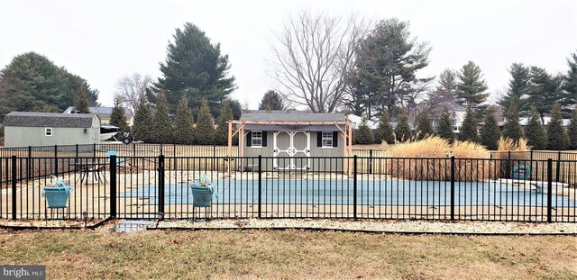 view of pool featuring a storage shed