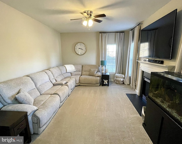 living room with ceiling fan and light colored carpet