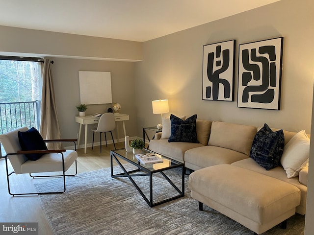 living area featuring baseboards and wood finished floors